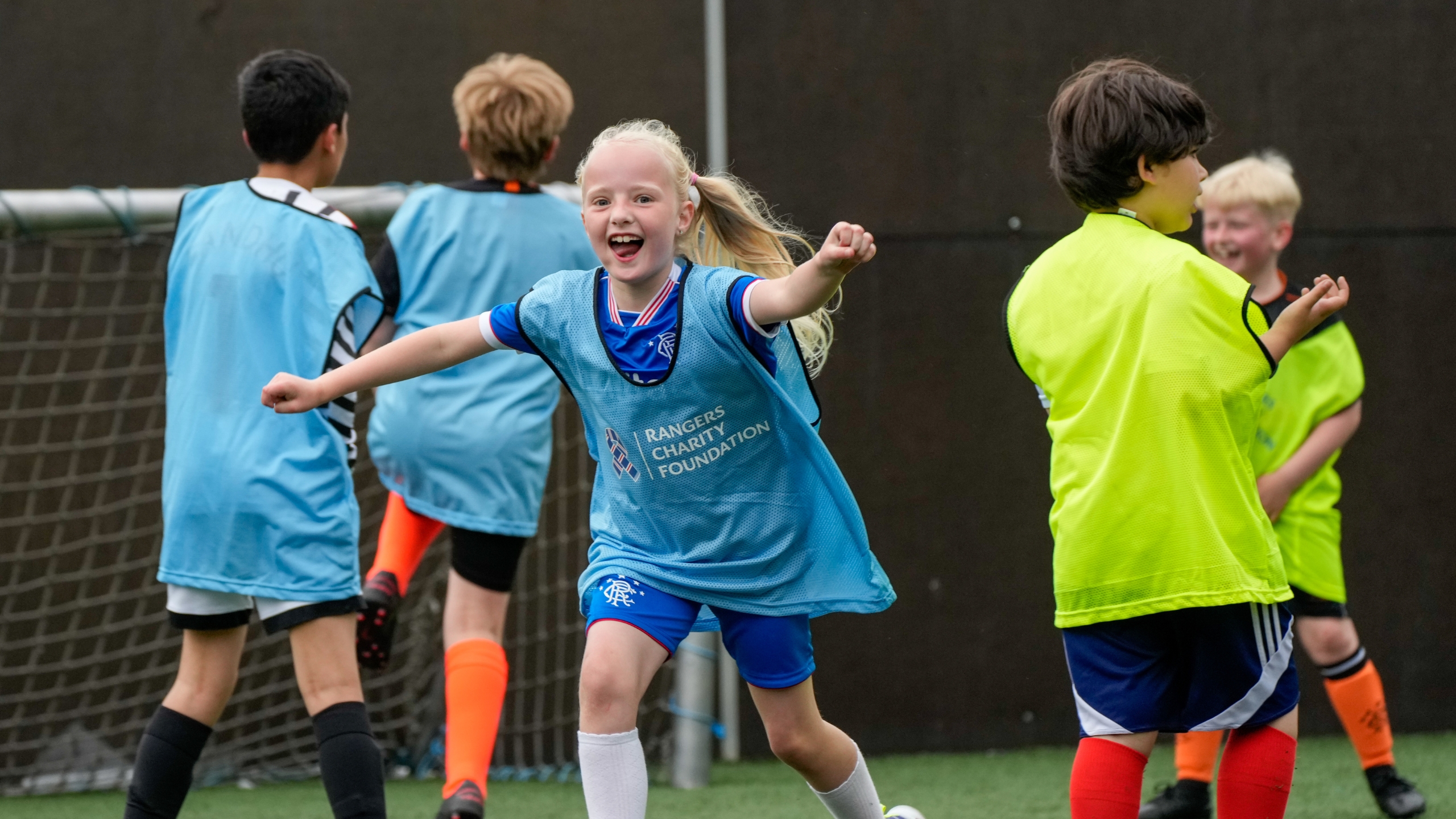 An Autism Friendly Football participant celebrating after scoring a goal