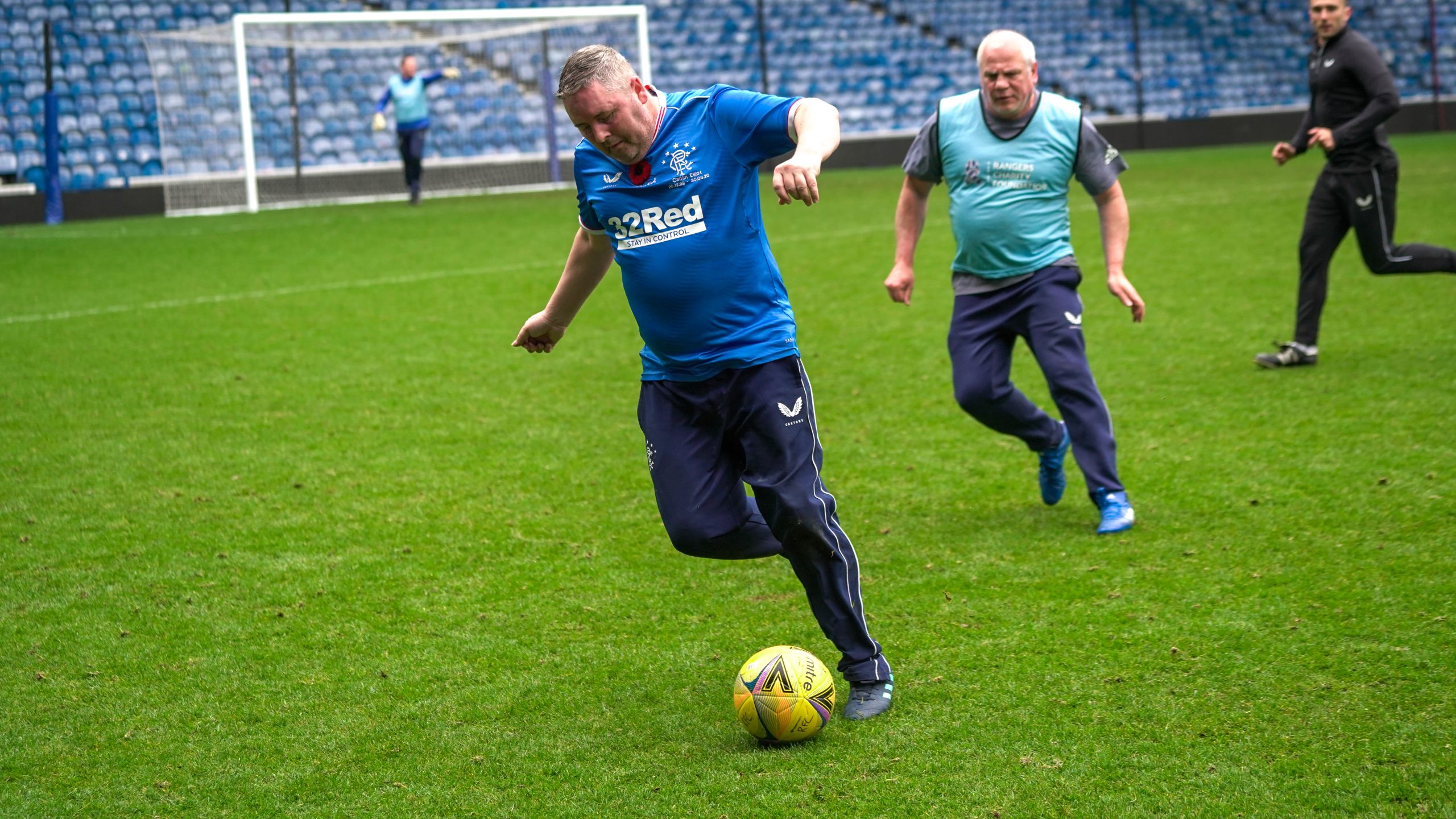 Man in a Rangers top playing football