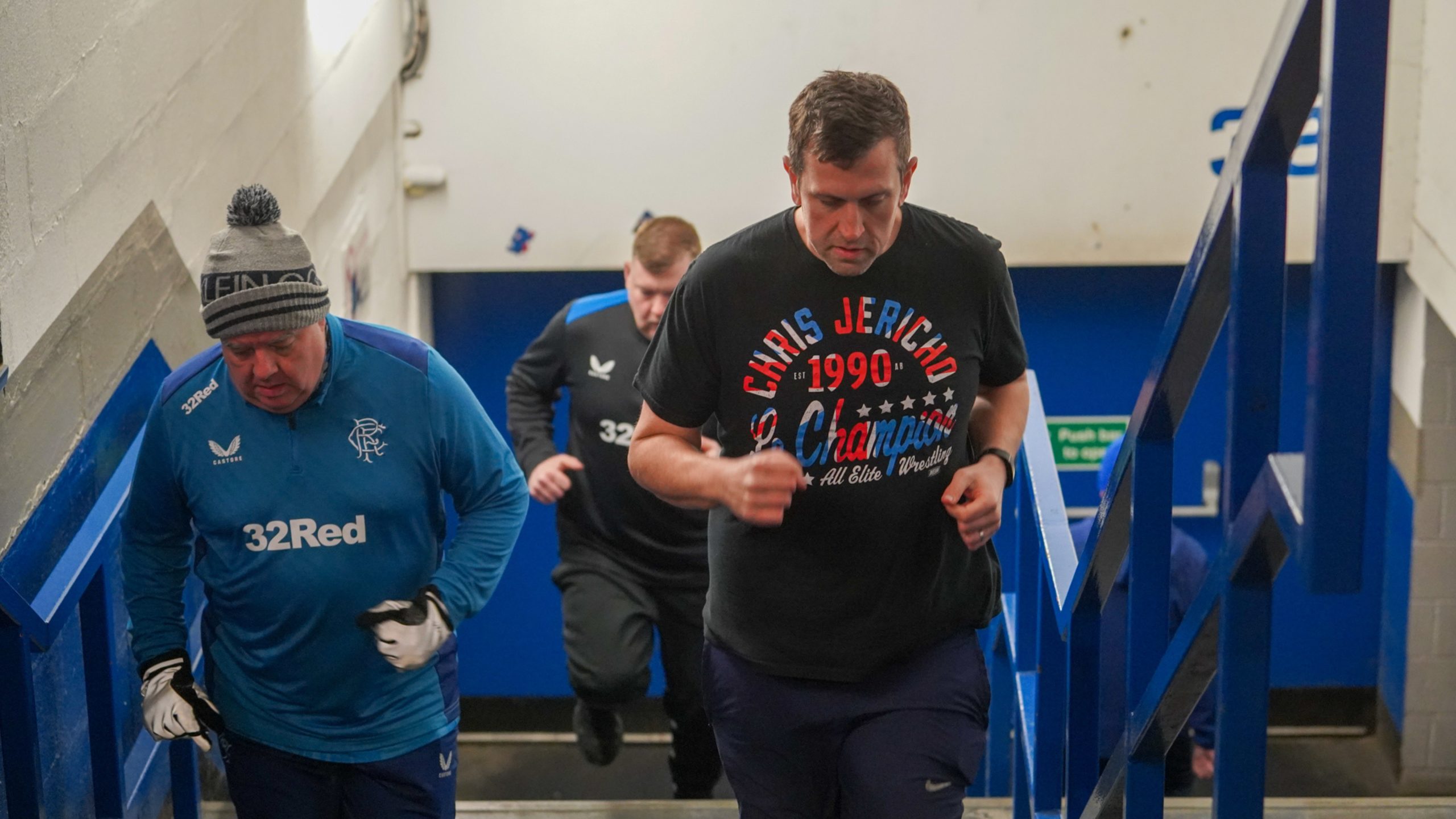 A group of men running up and down the stairs at Ibrox