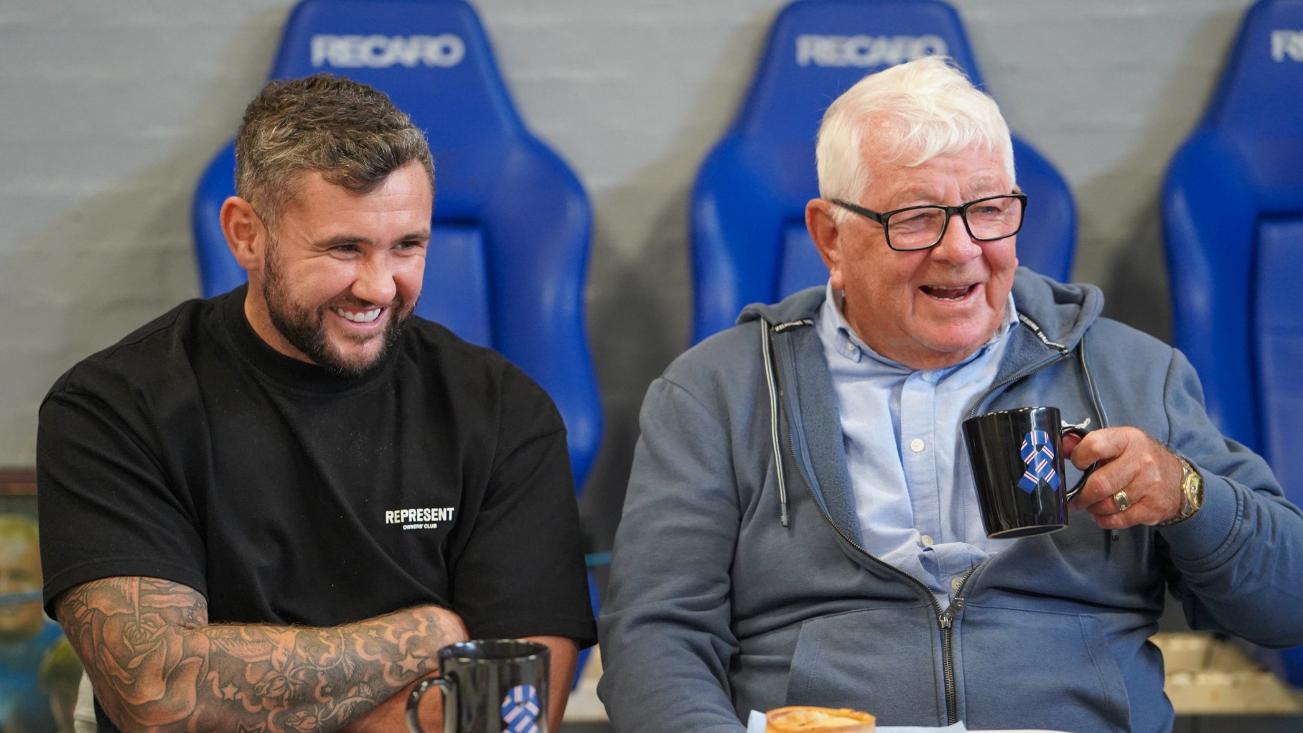 A man and a younger man having a laugh together