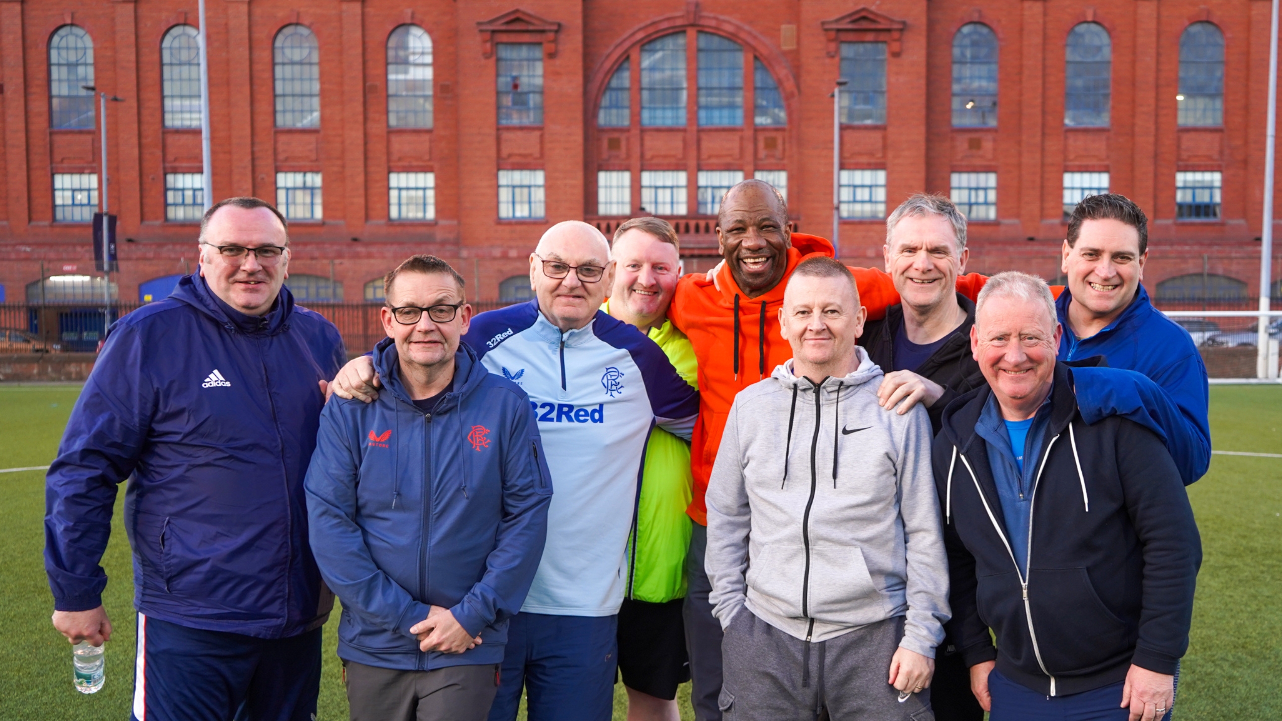 A group of men with former Rangers FC player Marvin Andrews standing in front of Ibrox