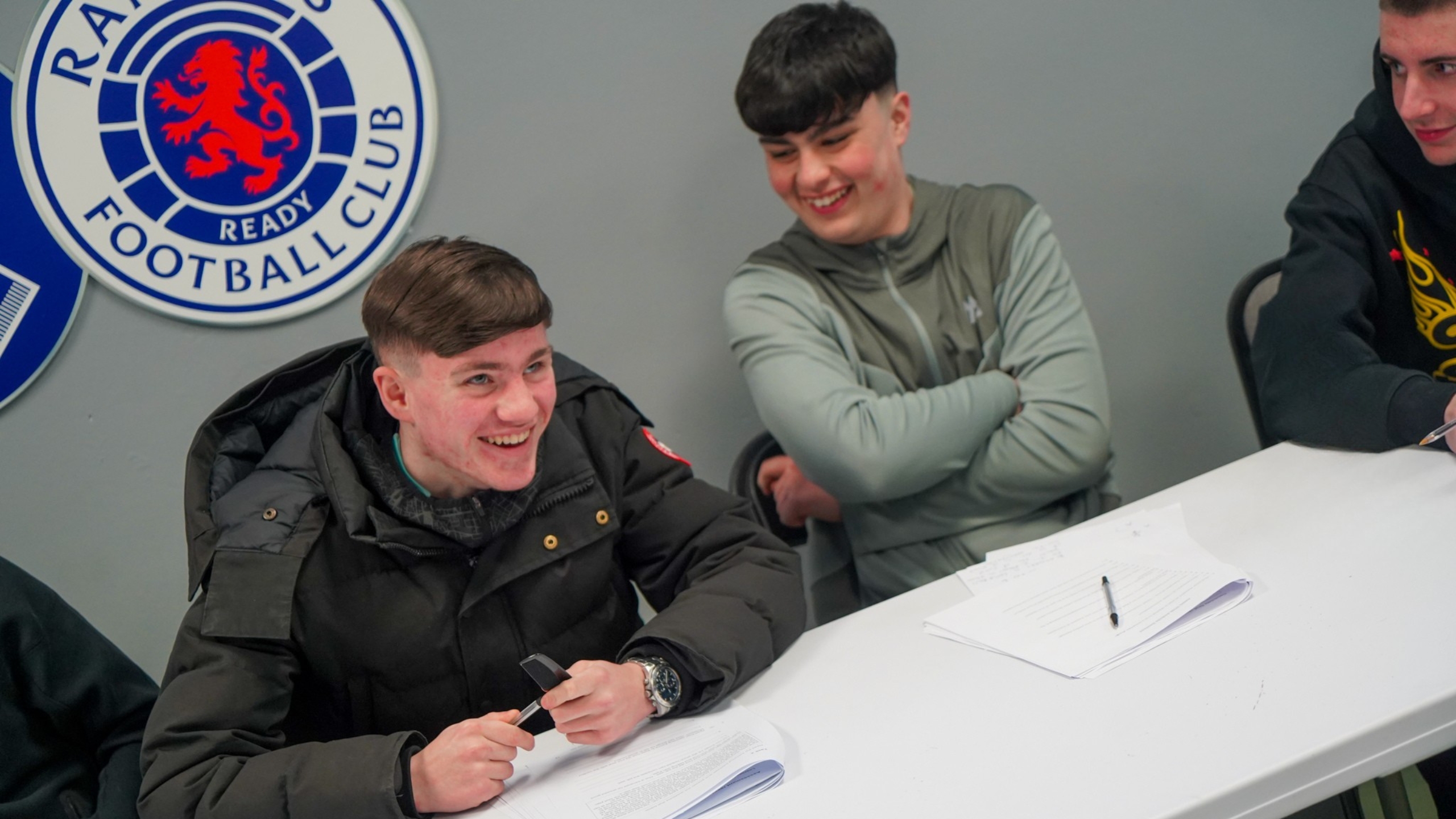 Two young men sharing a laugh as they complete course work.