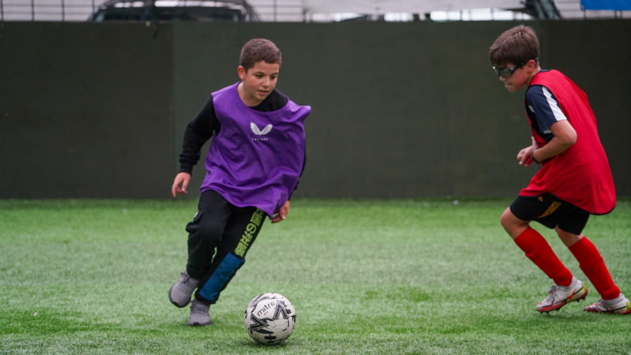 Two Visually Impaired Football participants playing football