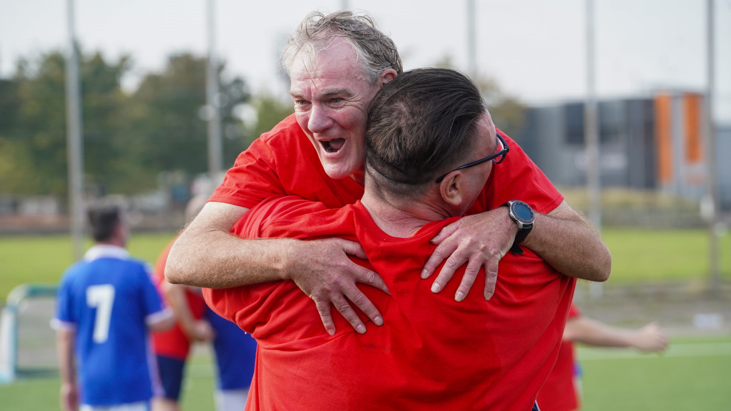 Two men celebrating after scoring a goal.