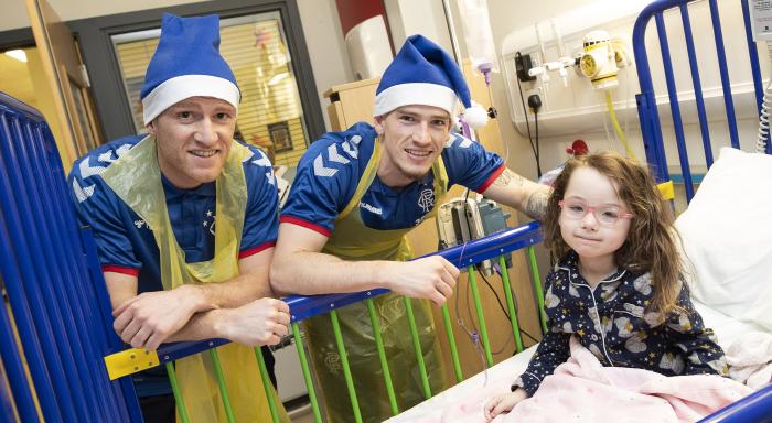 Two Rangers players visit a child in hospital at Christmas