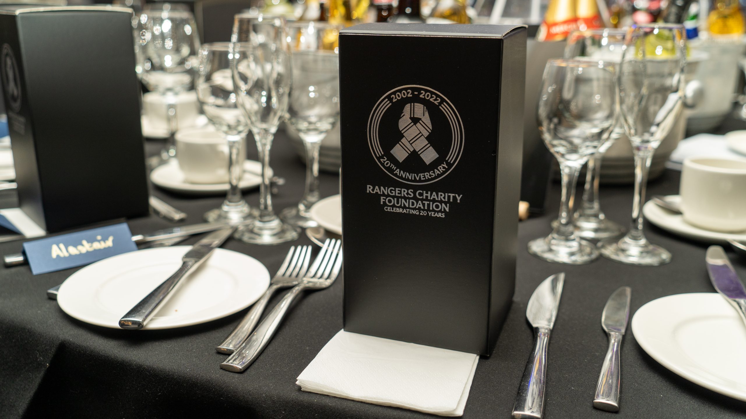 A Rangers Charity Foundation branded box on a dining table
