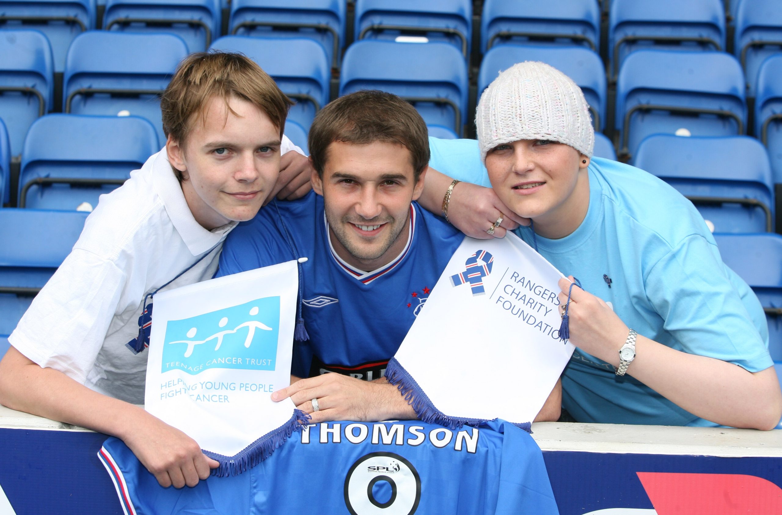 Kevin Thompson with two young people with cancer