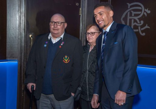 Man and women stand next to football player Tavernier in tunnel at Ibrox