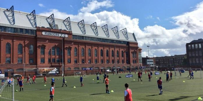 kids play football on the pitch at the Ibrox community complex