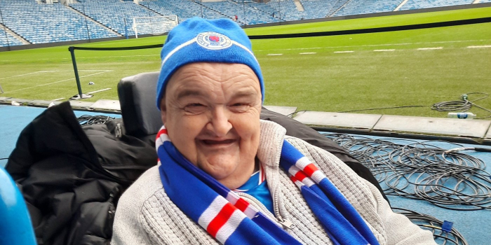 A person in a wheelchair, pitch-side at Ibrox