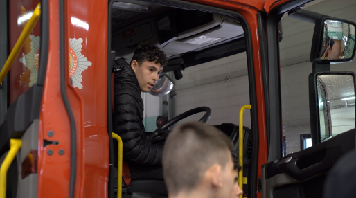 Young male sitting in fire engine