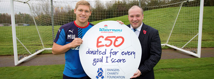 Martyn Waghorn and 1 man holding prop cheque of amount donated