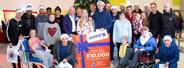 Approx 25 people during Christmas festive visit with prop cheque showing amount donated