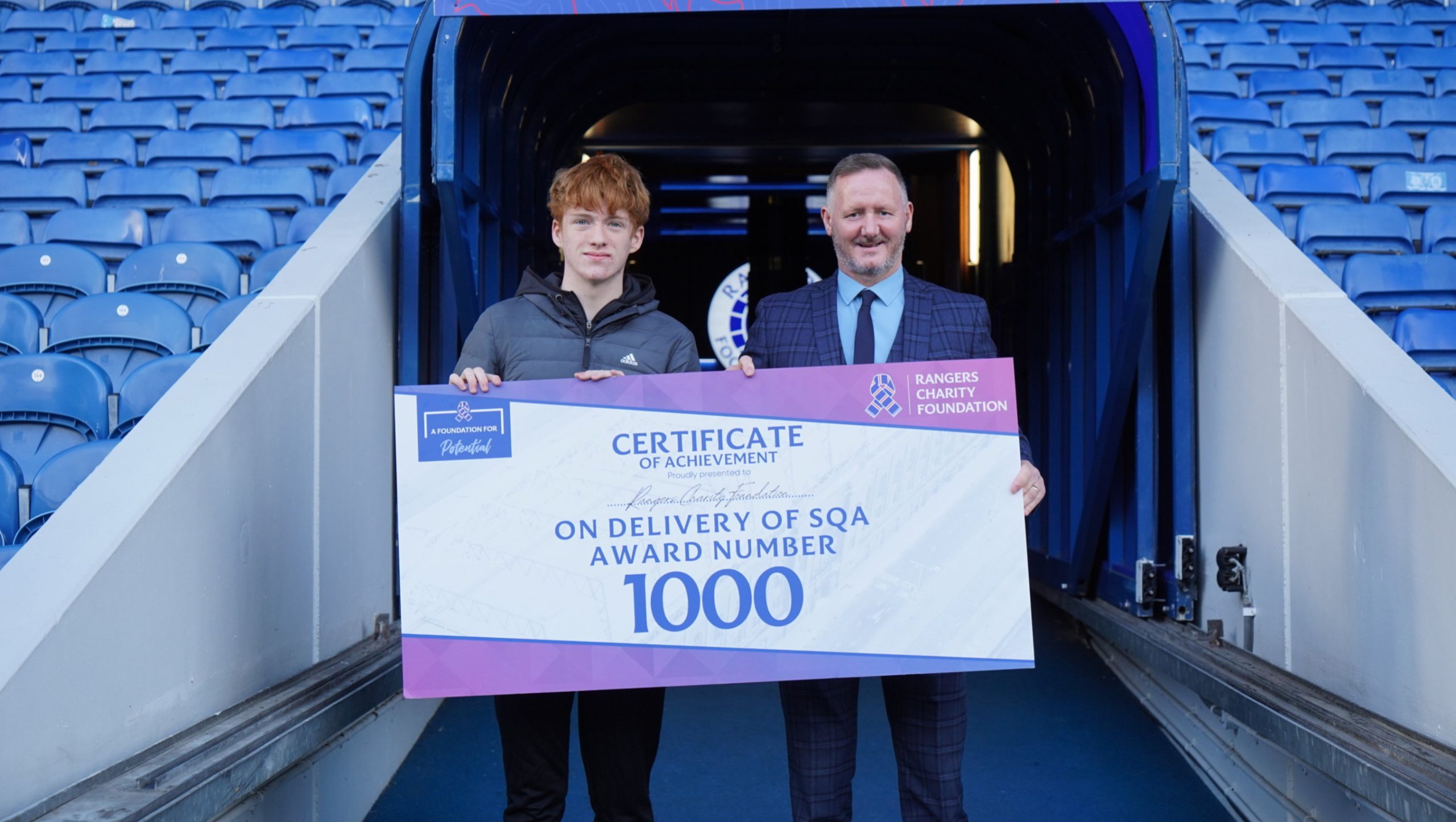 Jamie Duncanson and 1 Male holding SQA Prop