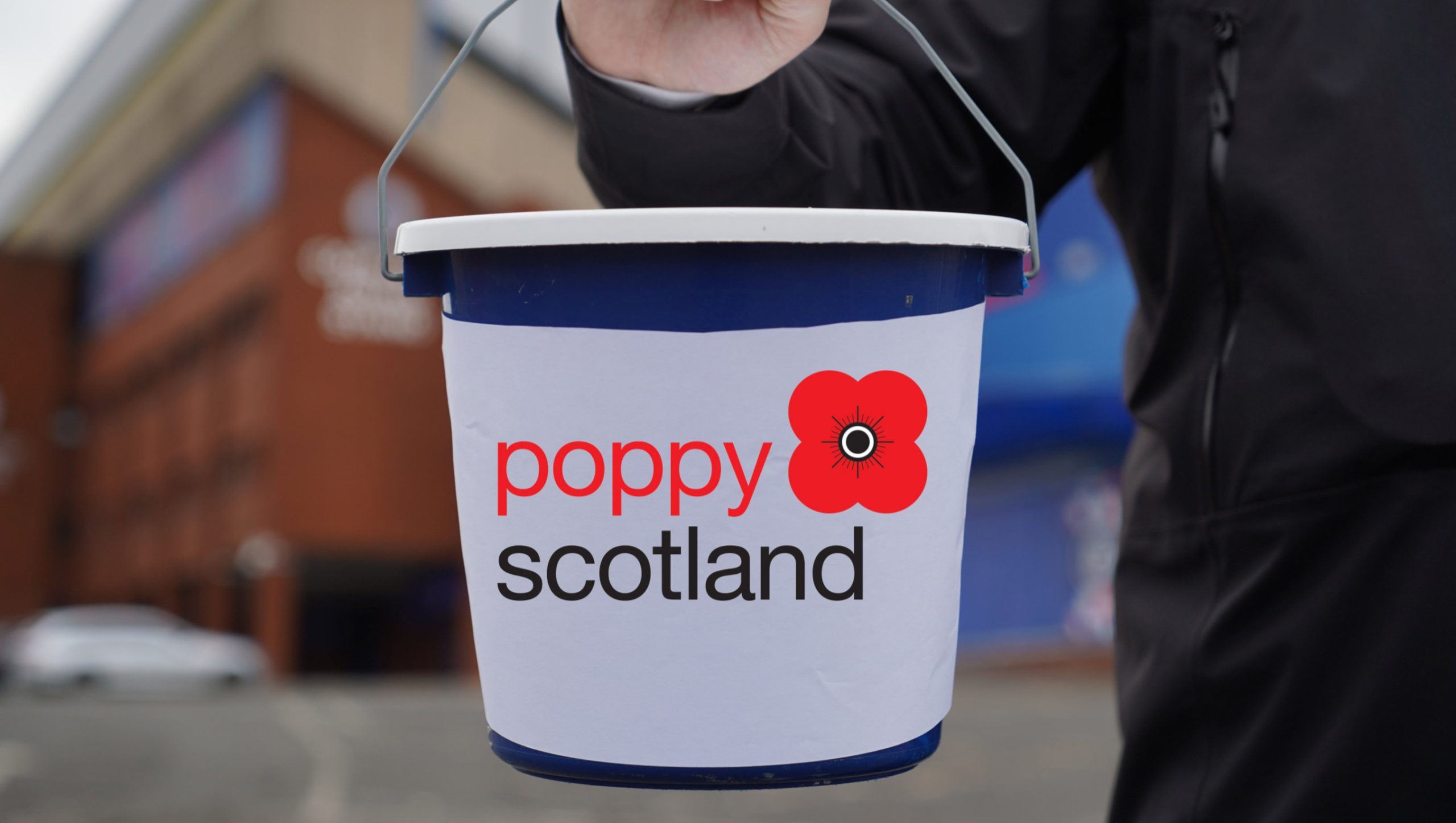 A bucket with the poppy Scotland logo