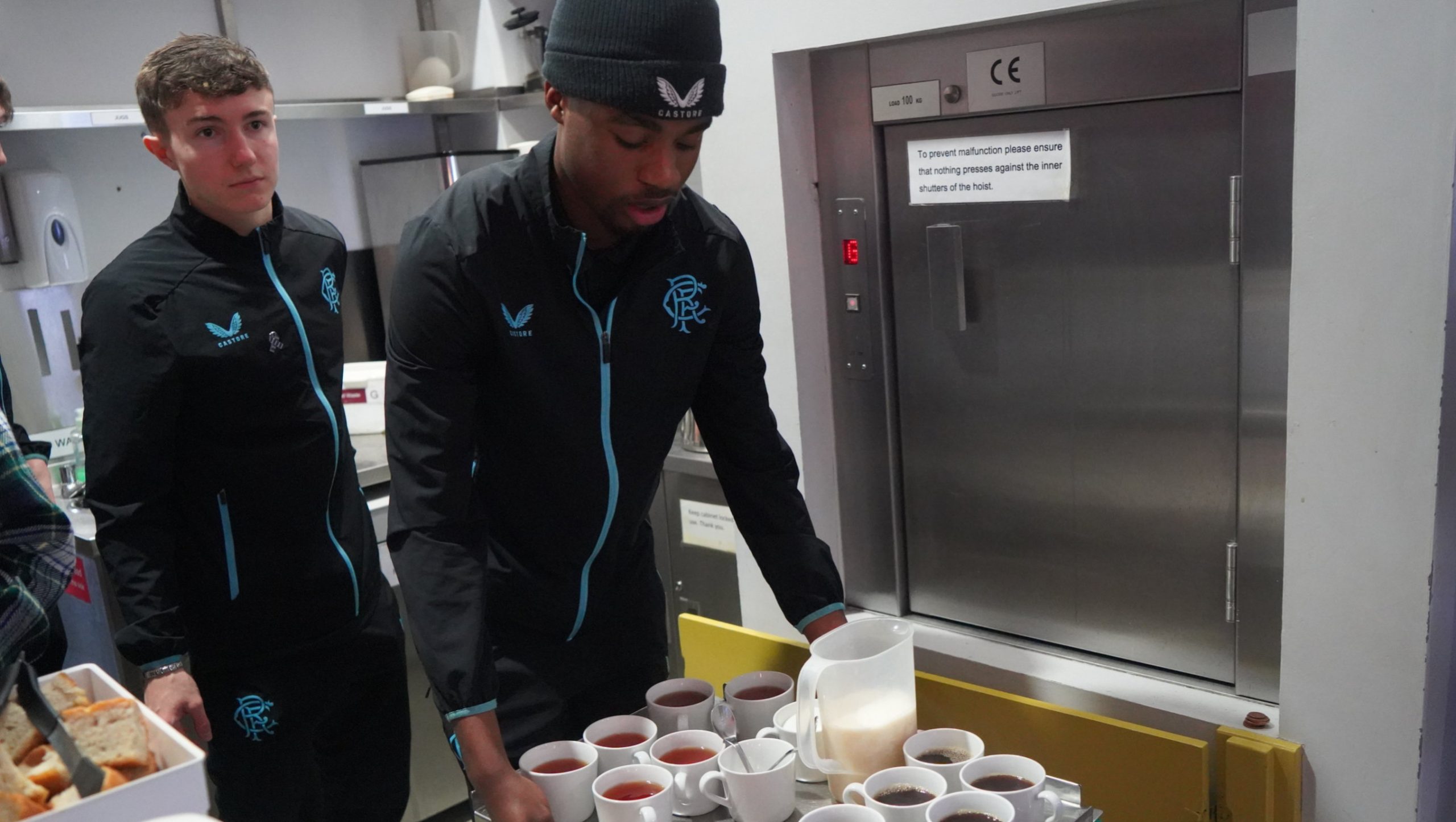 Academy players serving tea and coffee