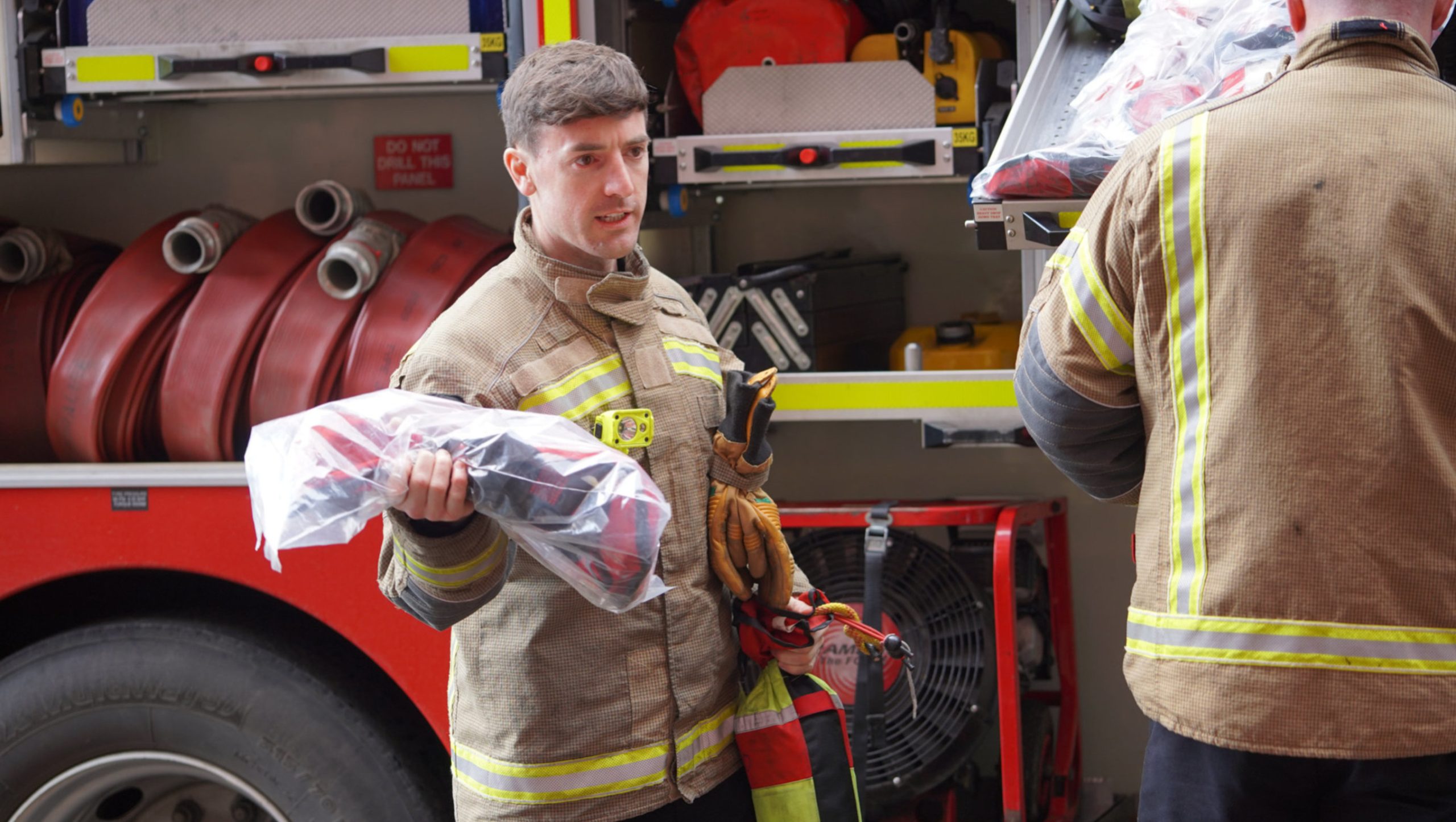 A firefighter holding equipment