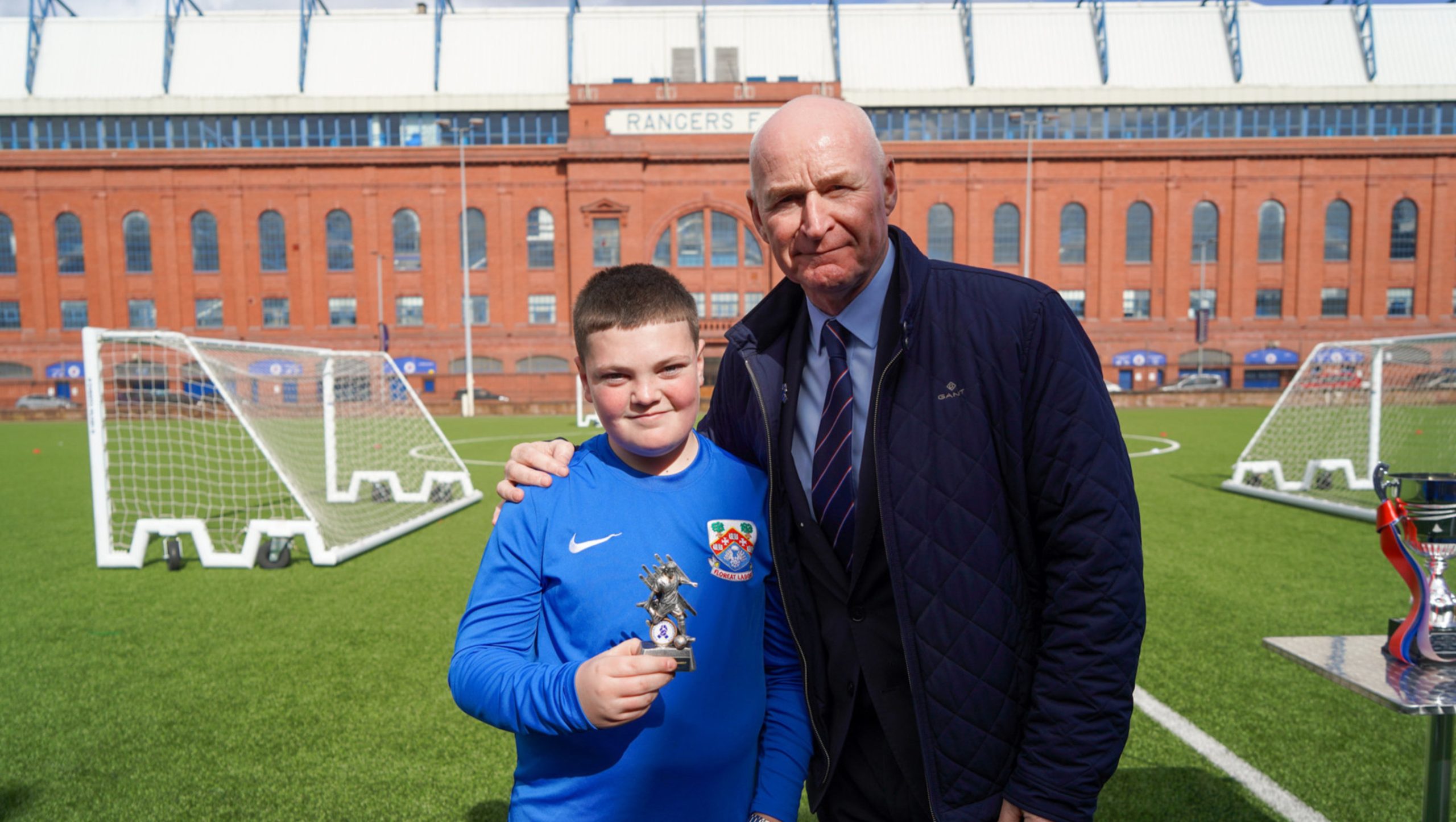 Former Rangers player John Brown presenting a Player of the match trophy