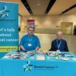 Derek standing at a Bowel Cancer info stall