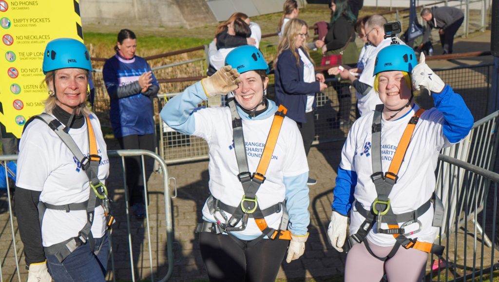 group of people in harnesses and helmets