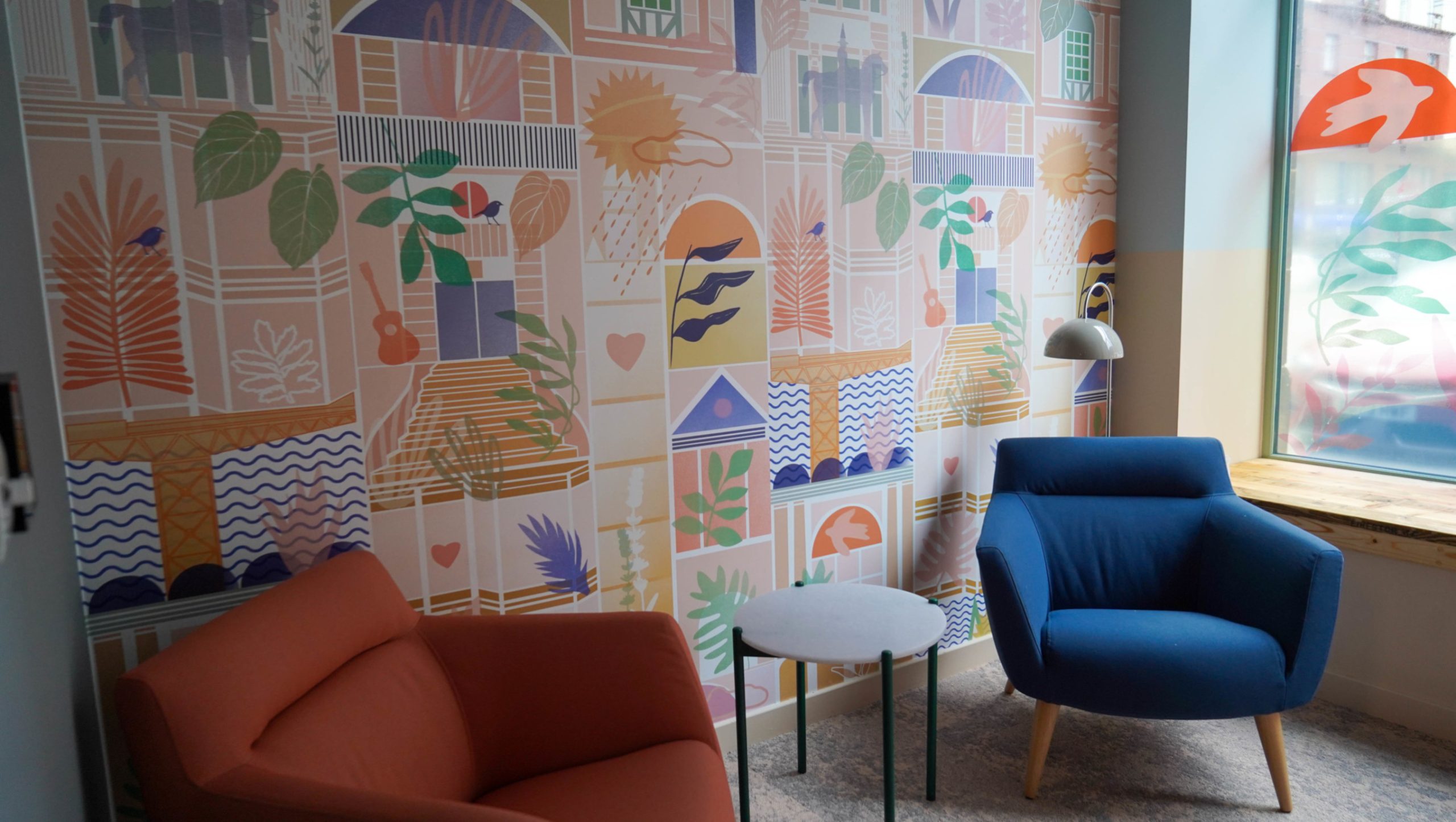 chairs and a table colourful wallpaper