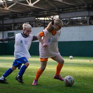 Two Visually Impaired Football participants taking part in a training session.