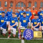A a squad of football players made up of CashBack participants and Foundation staff posing for a group photo in front on Ibrox