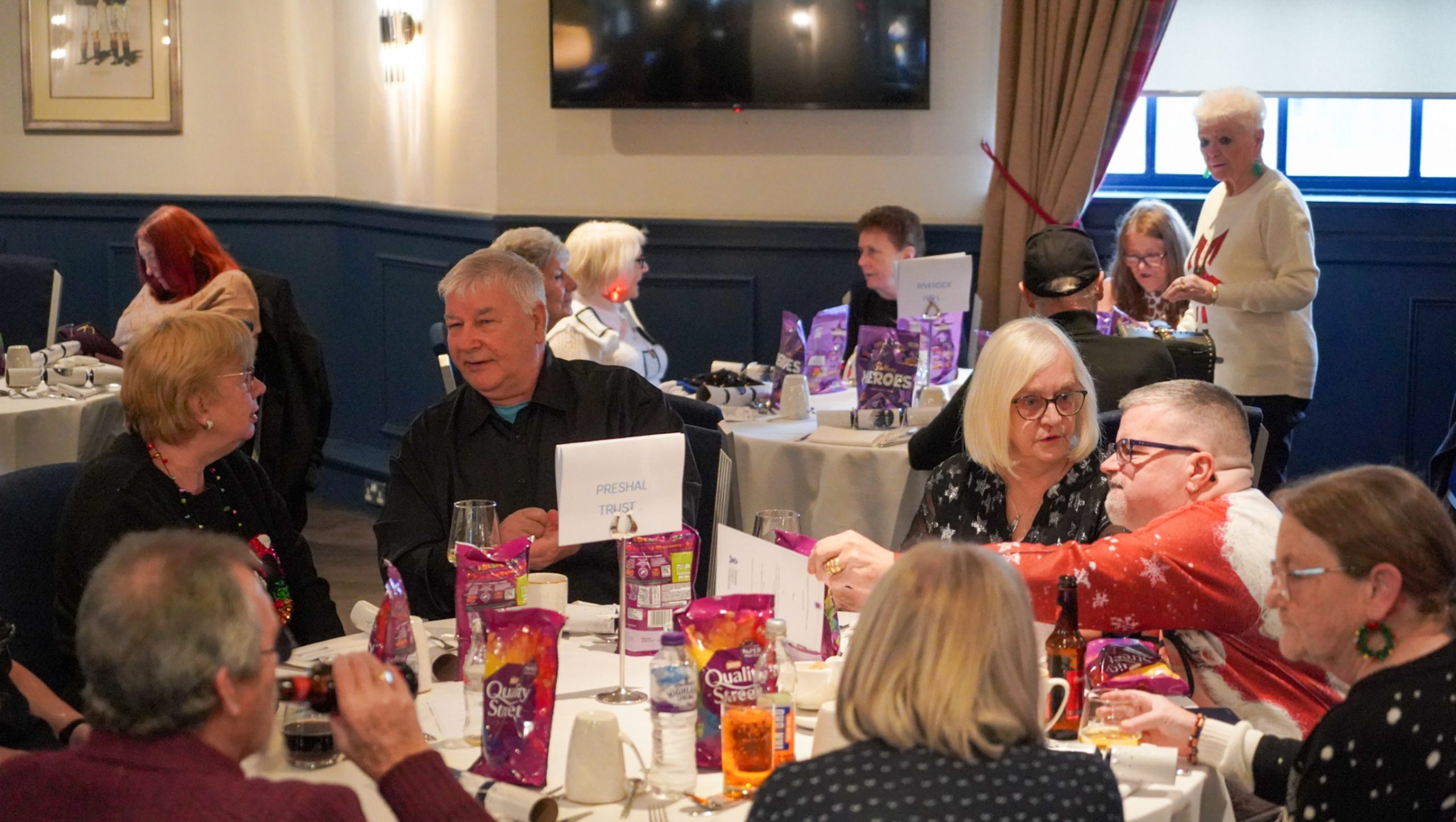 A group of senior citizens sitting down for lunch at Ibrox Stadium