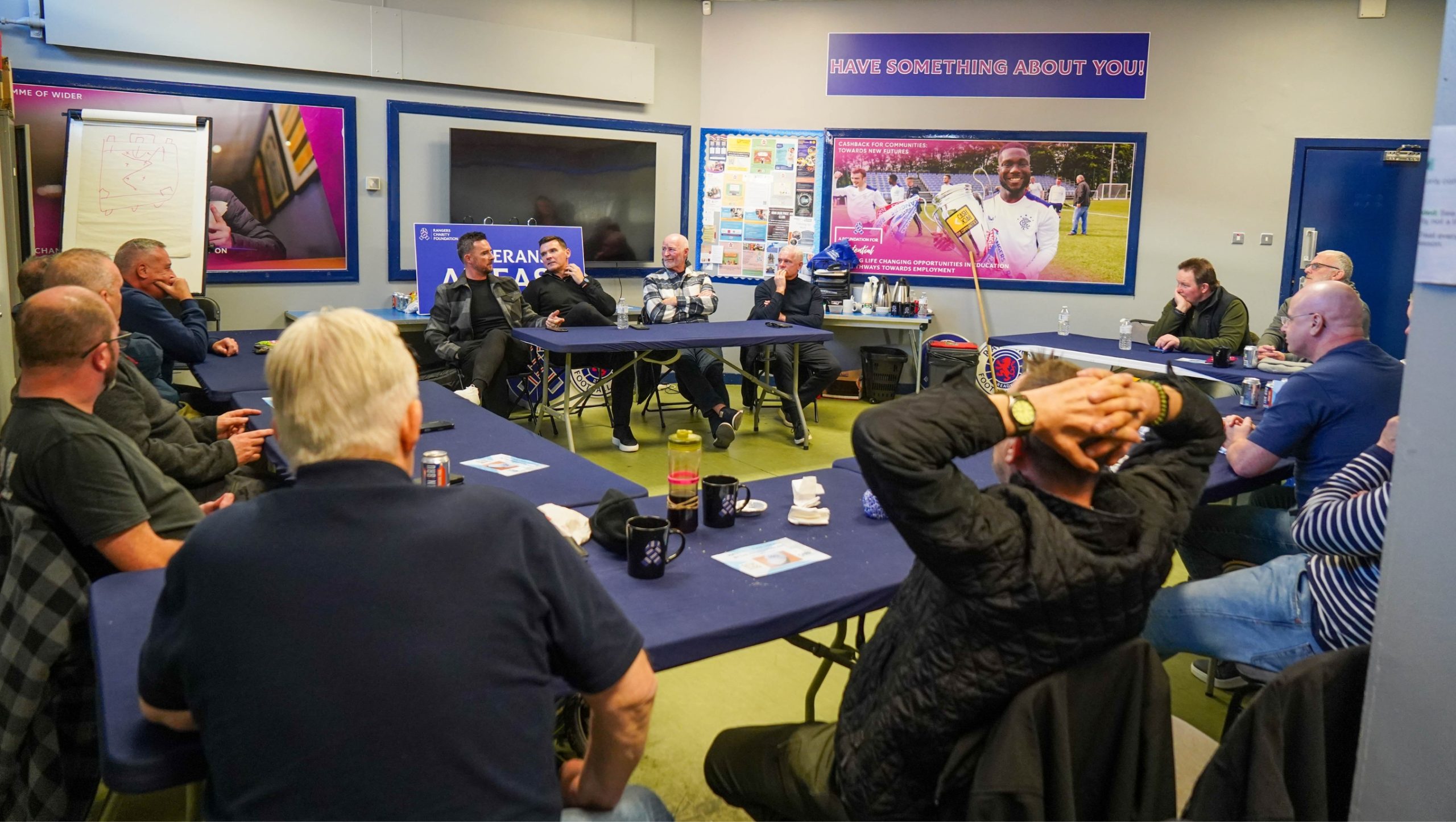 Barry Ferguson, Lee McCulloch, John Brown and Ian Durrant, sitting at a table talking to a group of Veterans.