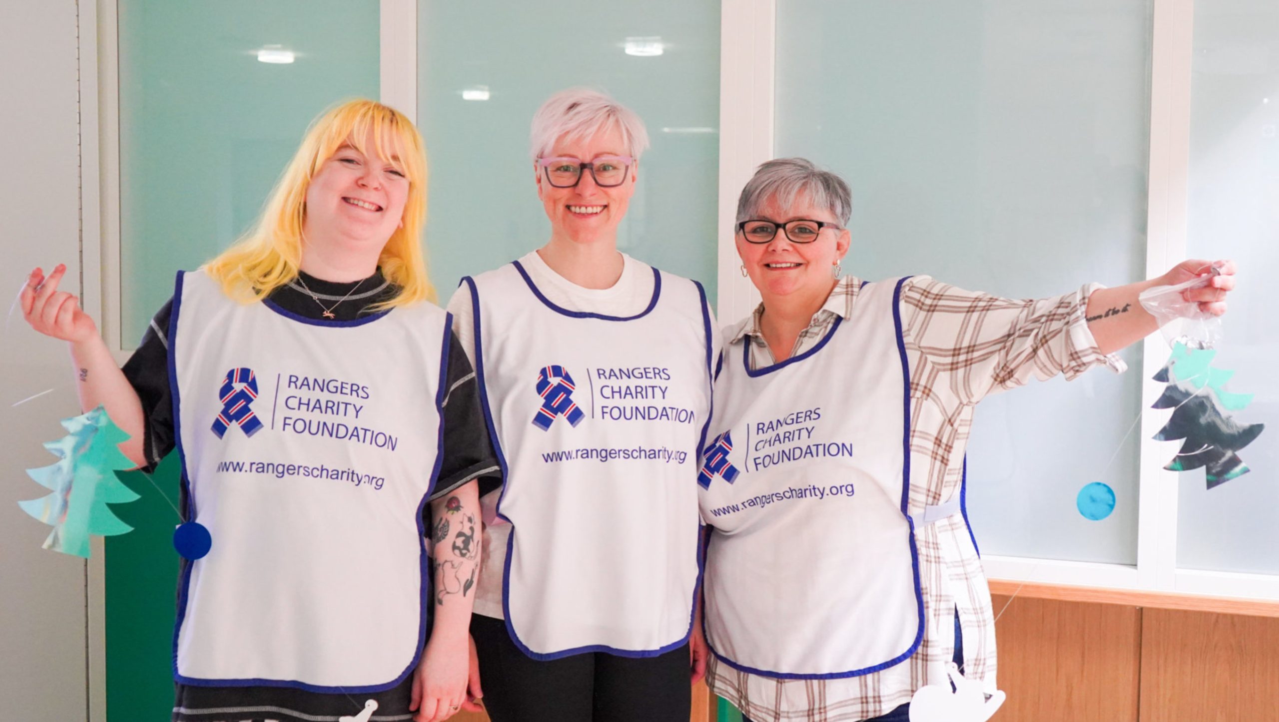 volunteers hanging Christmas decorations