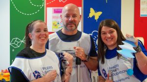 volunteers hanging Christmas decorations