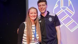 woman with medal with rangers player