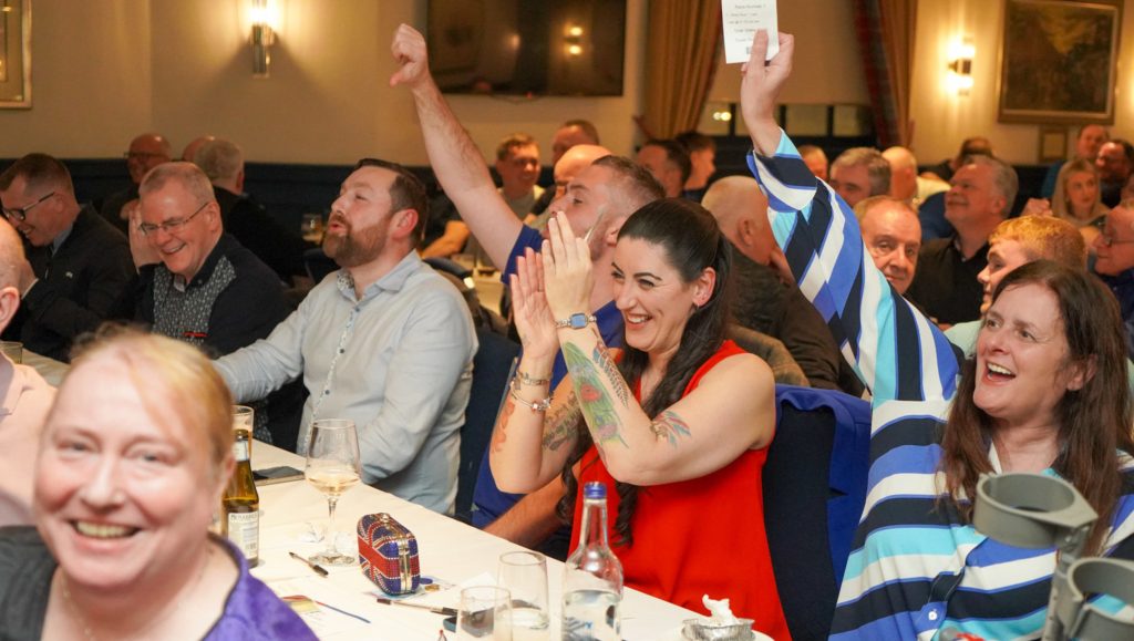 people cheering clapping and smiling