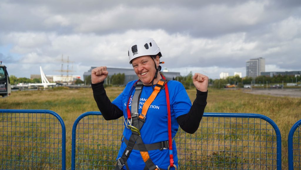 women giving thumbs up in harness and helmet