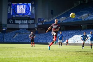 fans playing on the pitch at Ibrox