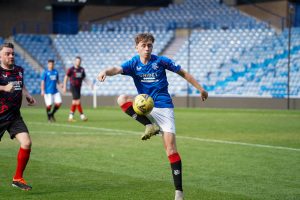 fan playing on the pitch at Ibrox