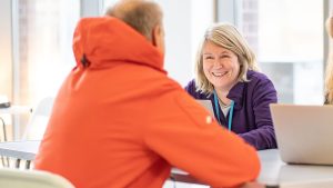 a man talking to a woman who is smiling
